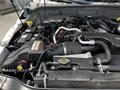 Close-up of the engine compartment of a 2016 Ford F-550 showing the air intake system and various engine components