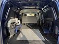 Interior view of a 2011 Ford Econoline van featuring an empty cargo area with a gray bench seat and a rubber floor mat