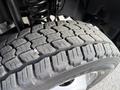 Close-up of a tire from a 2020 Ford F-550 showcasing a detailed tread pattern and visible wear on the rubber surface