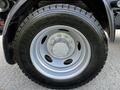 A close-up view of a silver alloy wheel and tire of a 2009 Ford LCF 550 with a size designation of 225/70R195