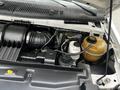 Engine compartment of a 2013 Ford Econoline featuring the air intake system cooling system reservoir and various engine components
