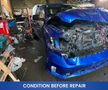 2019 RAM 1500 Classic with front damage and an exposed engine compartment parked in a cluttered garage setting