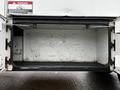 A 2013 Ford F-650 with an open compartment revealing an empty interior space