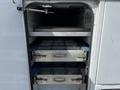 Interior compartments of a 2008 Ford F-550 showing two metal drawers stacked vertically with a flat surface above them