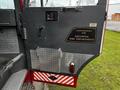 A 2009 Spartan Gladiator fire truck door featuring a metallic finish with a plaque that reads Custom Built for Kelowna Fire Department and silver diamond plate accents