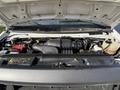 Engine compartment of a 2012 Ford Econoline E-450 showcasing the engine components and various mechanical parts