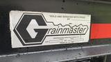 A label for Grainmaster attached to a vehicle showing the brand name and contact information along with the model and manufacturing details