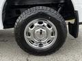 Close-up of the chrome wheel and tire of a 2016 Ford F-150 showcasing a rugged tread design and shiny rim