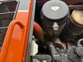 Close-up of the engine compartment of a 2018 Doosan DL300-5 featuring pipes filters and a black canister marked with a top label