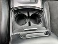 A center console with two circular cup holders in a 2022 Dodge Charger