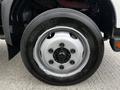 Close-up of a Bridgestone tire mounted on a silver wheel of a 2018 Hino 195 truck showcasing the lug nuts and tread pattern