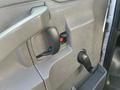 Detail of the door handle and window control on a 2018 Chevrolet Express