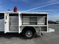 A 2017 Ford F-350 Super Duty truck with an open utility service bed featuring numerous metal tool drawers and compartments