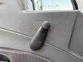 A window crank handle mounted on the interior door panel of a 2015 International DuraStar 4300