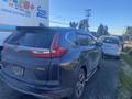 A 2019 Honda CR-V parked alongside another vehicle with a muddy exterior and visible all-wheel drive badge