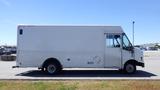 A white 2006 Ford Econoline cargo van with a boxy design and a large cargo area visible from the side