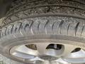 Close-up of a tire on a 2015 Fiat 500L showcasing the tread pattern and alloy wheel design