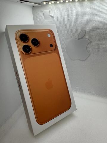 An Apple iPhone 17 Pro Max 512GB in a gold box featuring a rear image of the phone with three camera lenses and the Apple logo