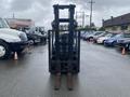 2011 Toyota 028FG15 forklift facing forward with raised forks and empty mast