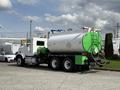 A white 1996 Kenworth T800 truck with a large green and white tank attached to its rear and various equipment on top