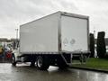 A white 2017 Freightliner M2 106 box truck with a closed rear door and reflective markers on the sides