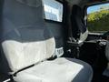 Interior view of a 2005 Volvo VND 122 featuring two grey fabric seats and a control panel between them