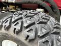 Close-up of a heavily treaded tire from a 2012 Toro Groundsmaster showing prominent angular patterns on the surface