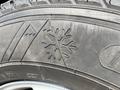 Close-up of a tire tread featuring a snowflake design indicating winter tire capability on a 2013 Ford Expedition