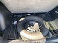 The trunk of a 2023 Ford Bronco Sport containing a spare tire and tools arranged neatly on a black rubber surface