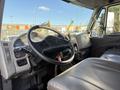 Interior view of a 2017 International 4300 truck featuring a black steering wheel dashboard and leather seats