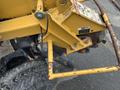 A yellow 2014 Vermeer Corporation Sweep Stump Cutter with visible rust on metal components and a textured tire on the side