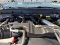 The engine compartment of a 2014 Ford F-250 SD showcasing various components including hoses and an air intake system