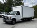 A white 2018 Ford Econoline box truck with a sliding door on the side and a large rectangular cargo area
