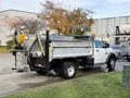 A 2012 Dodge Ram 5500 pickup truck with a flatbed and a dump feature parked on a driveway