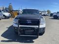 A 2013 Ford Expedition with a black front grille and a grill guard is parked facing forward
