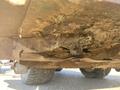 Undercarriage of a 2010 Kubota F3680 showing rust and accumulated debris on the metal parts and a visible wheel axle