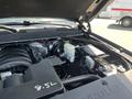 Engine compartment of a 2016 Chevrolet Tahoe showcasing the engine block battery and various components