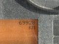 A close-up of an odometer displaying the mileage of 69928 KM on a digital screen