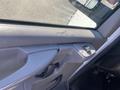 Close-up of the interior door panel of a 2012 GMC Savana showing the door handle and window control buttons
