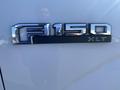 Chrome badge of a 2017 Ford F-150 XLT prominently displayed on the side of the truck