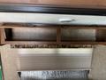 A wooden overhead cabinet with two open compartments inside a 2016 Jayco 265RLSW camper