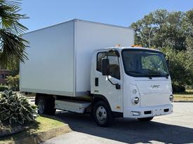 A white 2024 VMC 1200 delivery truck with a boxy cargo area and front-facing headlights parked on a driveway