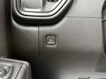 Close-up of the parking brake button in the interior of a 2022 GMC Sierra 1500