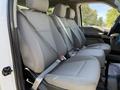 Interior of a 2018 Ford F-150 showing three gray fabric front seats with seat belts and headrests