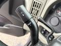 A close-up of the turn signal and headlight control lever on a 2014 International TerraStar with markings for various functions and settings