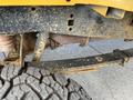 A 2017 Ford F-250 SD undercarriage showing a dirty frame with rusted exhaust parts and a rugged tire tread visible in the foreground