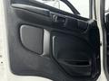 The interior door panel of a 2020 Hino 338 featuring a black plastic finish with a handle and armrest design