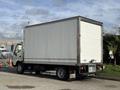 A 2014 Hino 195 truck with a white box cargo area parked with a visible Hino logo on the rear license plate