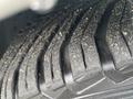 Close-up of a tire tread from a 2007 Mercedes-Benz E-Class showing detailed grooves and a slightly worn surface