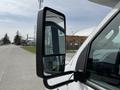 Side mirror of a 2010 Ford Econoline showing a clear view without distortion